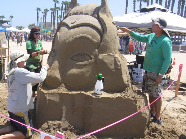 This sculpture by the San Squirrels honors a former member. I believe her name was Shera. Her surviving brother works with sand for the first time.