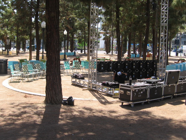 Lawn chairs face a stage.