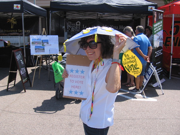 This lady registering people to vote had a cool lemon slice umbrella hat and smile.