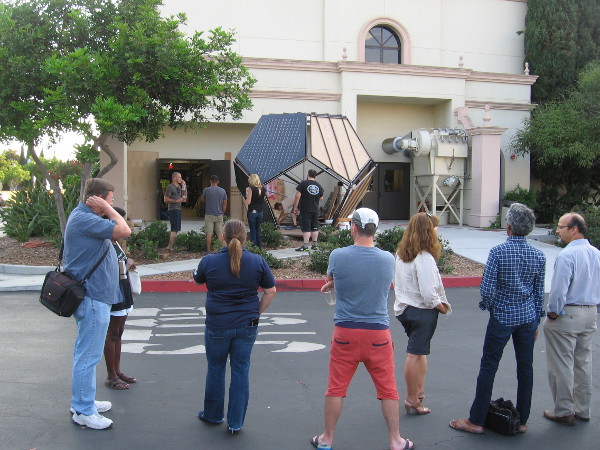 Students, faculty and interested visitors watch work being done on Unfolding Humanity during its debut at University of San Diego.