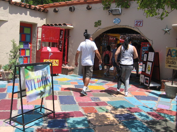 Visitors to the Spanish Village Art Center in Balboa Park walk through a sunlit paradise of color and creativity.
