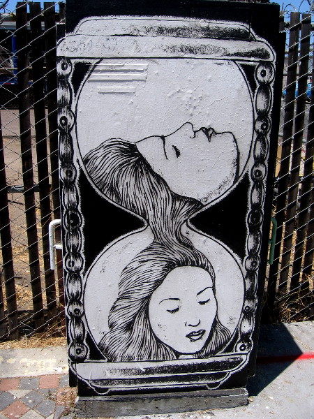 Female face flows like sand through an hourglass. Beautiful street art on a utility box on Cesar E. Chavez Parkway in Barrio Logan.