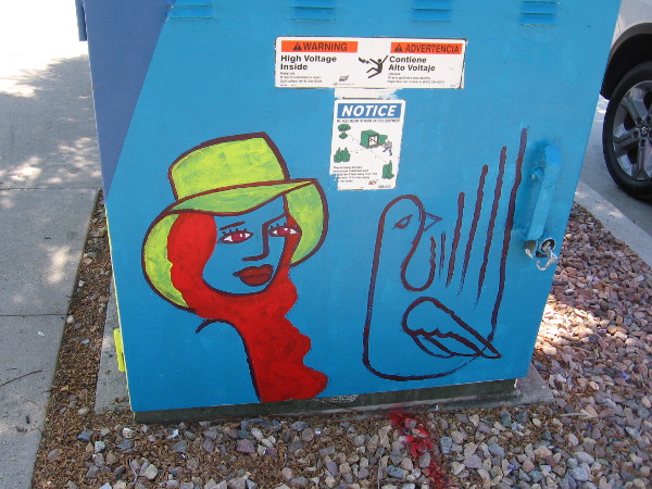 Fun street art on another side of the electrical box on Cesar E. Chavez Parkway includes a face.