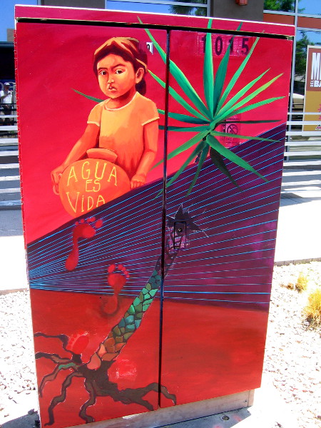 Boy carries earthen jug. Agua es vida. Water is life.