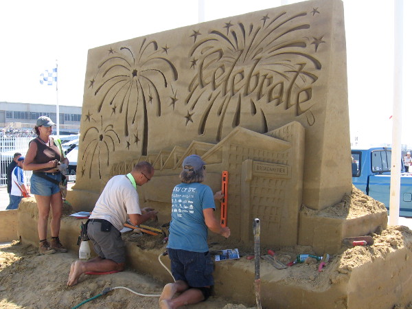 A sand sculpture rises at the foot of Broadway Pier in San Diego. It depicts fireworks above the Port Pavilion, site of the 2018 U. S. Sand Sculpting Challenge on this upcoming Labor Day weekend!