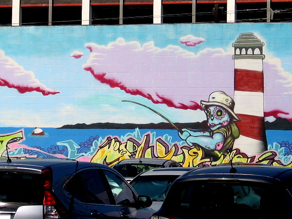 Part of a long mural on the back of a building behind the Park 'N Fly Lot 1 on Pacific Highway.