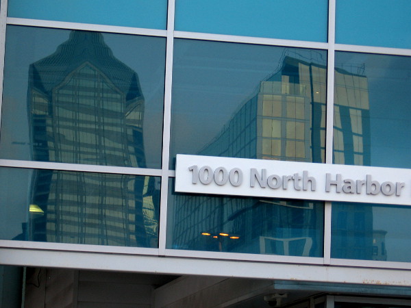 Downtown buildings reflected in windows of the Port Pavilion on Broadway Pier.
