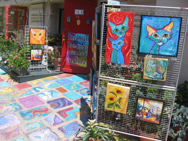Colorful cats have gathered on the patio in front of Studio 16 in Spanish Village.