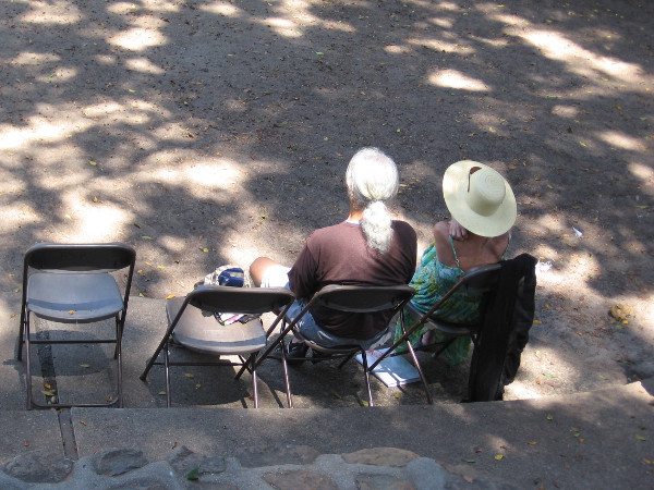 Two in the audience listen to powerfully spoken truth.