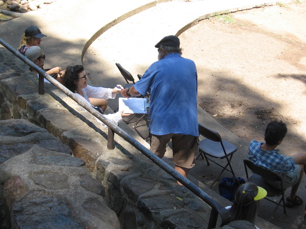 Someone in the audience signs up to read a poem. Anybody could participate during the event.