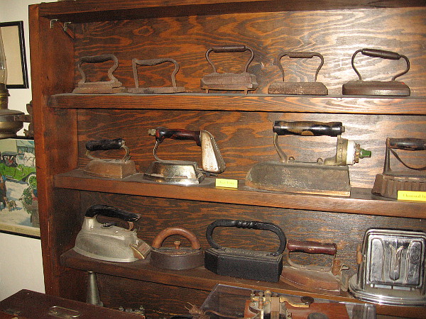 Shelves filled with old irons.