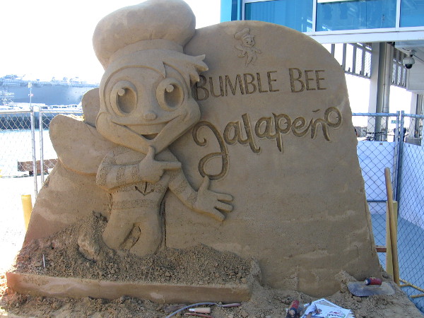 Bumble Bee Jalapeno is advertised with a fun sand sculpture in front of the Port Pavilion.
