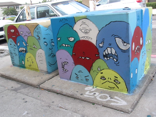 Bunches of odd, globular faces make for some unique street art.