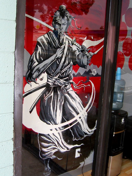Cool art in a window of Allegory Tattoo.