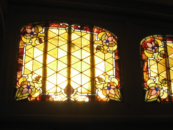 Sunlight brightens west-facing art glass windows on the passenger deck of the steam ferry Berkeley.