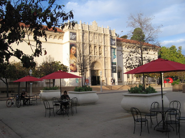 Resting at tables in the Plaza de Panama near the front of the San Diego Museum of Art.