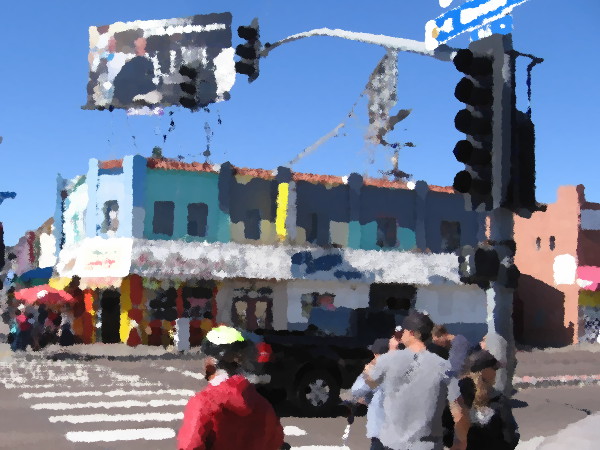 People wait to cross Mission Boulevard in Mission Beach.