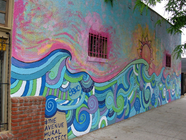 The first mural painted by The Avenue Mural Project in City Heights contains joyful swirls of many colors! Endless Summer was designed by artist Erin Bowman.
