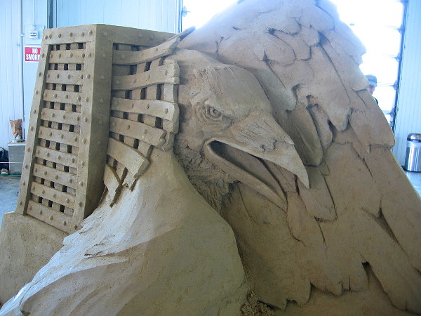 An eagle is liberated from a cell-like cage. Dynamic sand art with great emotional impact.