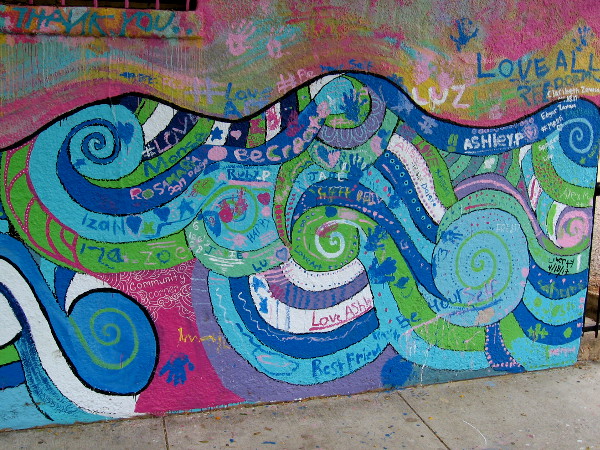 The Endless Summer mural was painted by local school children, whose names appear in one corner, along with many positive messages.