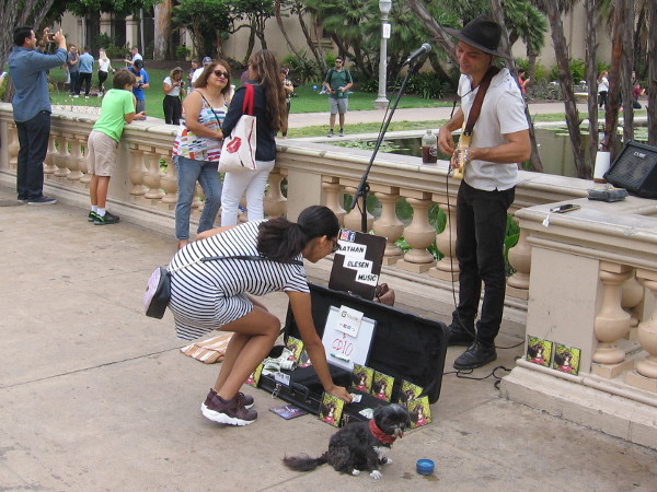A street musician smiles on a sunny Labor Day in Balboa Park.