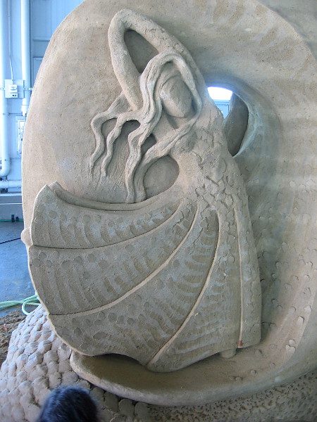 A closer photo of the graceful, organic sand sculpture.