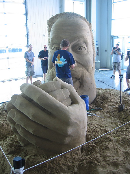 This photo makes it appear as though huge hands are clasping the artist Abram Waterman.