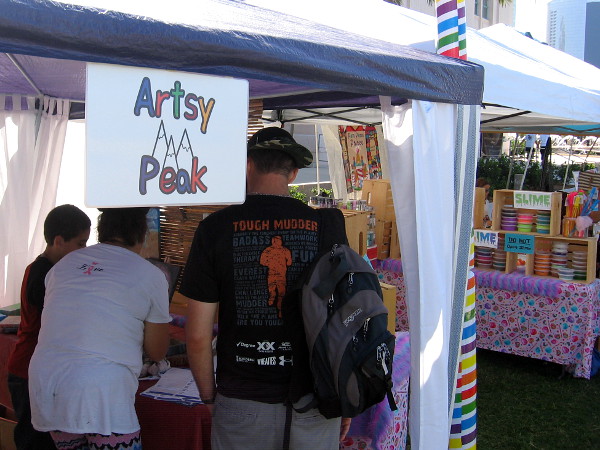 A young artist was showing his great artwork at his booth called Artsy Peak.