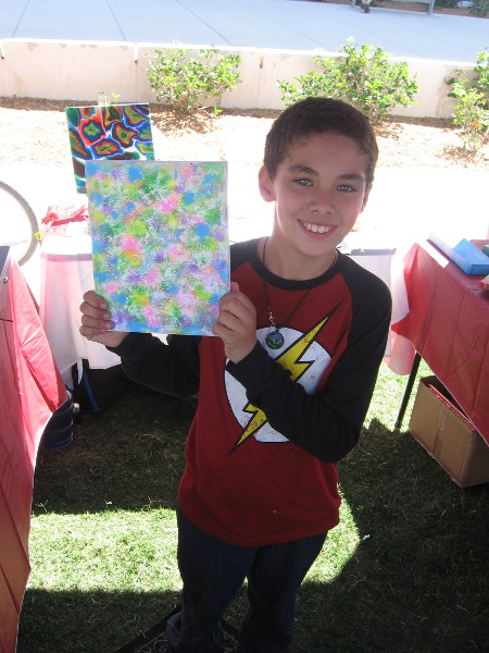 The smiling young man shows his super colorful artwork!