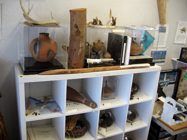 Various human artifacts on display include Native American Kumeyaay clay pots, weapons and tools.