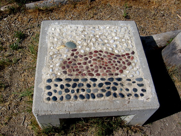 Several small concrete seats were decorated with colored stone mosaics. This one features a mallard duck.