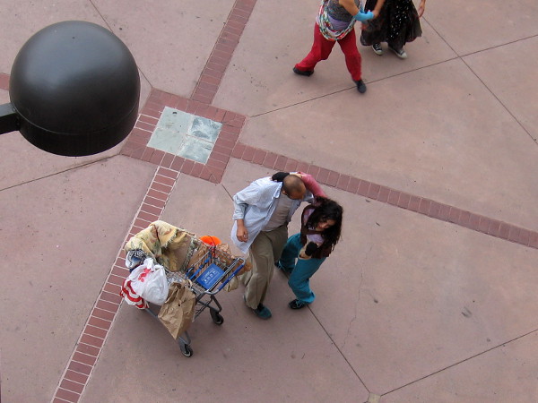 A shopping cart is a focal prop. Seen from above, it is actually empty.