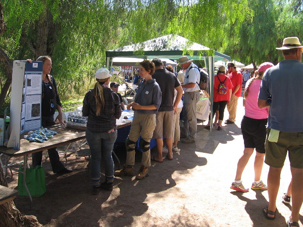Visitors check out displays by colleges, businesses and organizations concerning the region's archaeology, anthropology and natural environment.