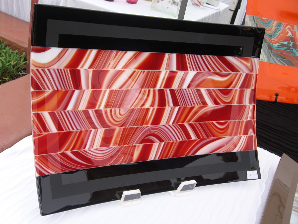 This photo and the next show kilnformed art glass produced by Rick Knight Designs. The tray is made of glass strips that are shifted and fused back together.