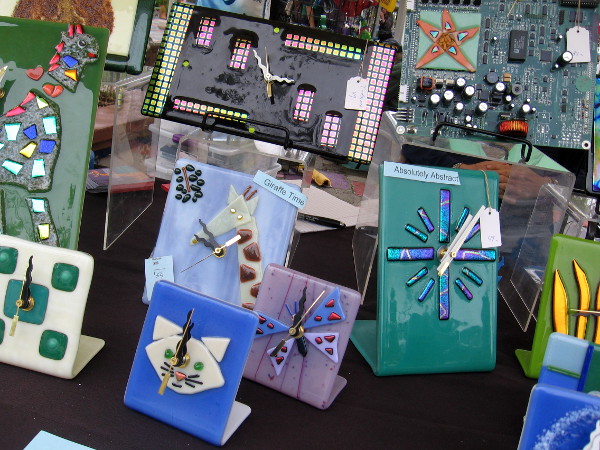 These clocks, some made with circuit boards from discarded computers, are the fused glass creations of The Glass Giraffe, Carol Korfin, artist.