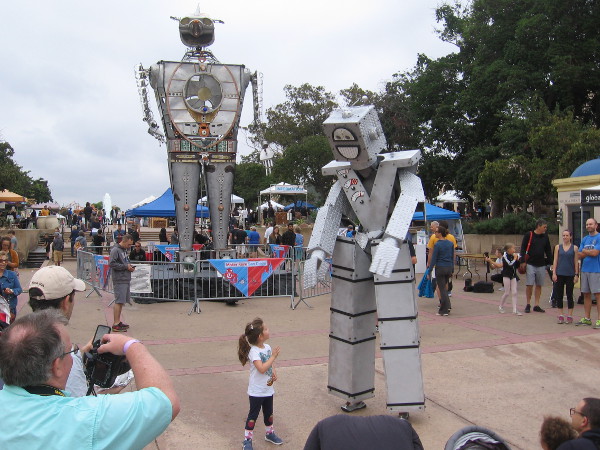 A small human meets friendly Know Mann - Giant Robot Puppet!