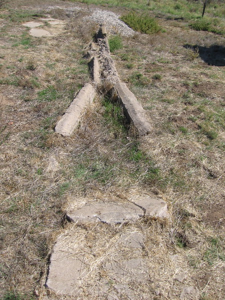 Walls and drainage structures poke out from the field. Their exact story is a puzzle that will eventually be pieced together.