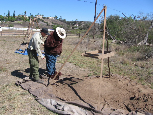 Smokey Bear checks out debris left on the ground in another corner of the field, the area used for dry screening.