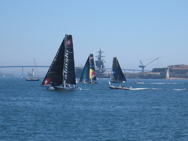 The super fast, hydro-foiling GC32 catamarans begin to maneuver before the first race begins. Seven teams would participate this weekend on San Diego Bay.