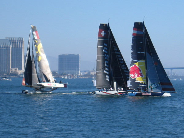 The race has begun! One catamaran tips upward in the wind, as its crew tries to obtain maximum speed.
