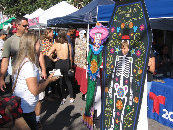 Boy poses for photo as a Day of the Dead skeleton with top hat.