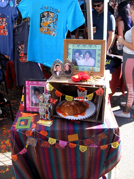 Another small altar (or ofrenda) included photos of deceased loved ones, papel picado, and pan de muerto.