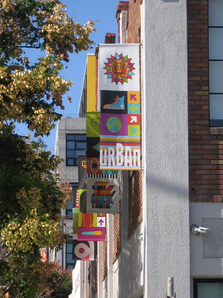Colorful banners along the side of Urban Discovery Academy in East Village.