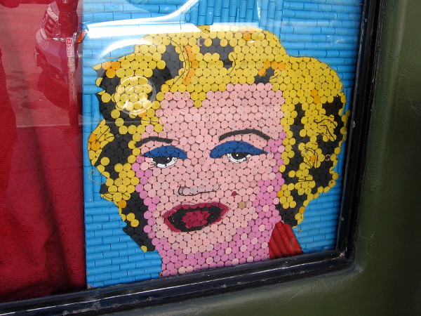 An artistic blonde peers out from a shop window in East Village!