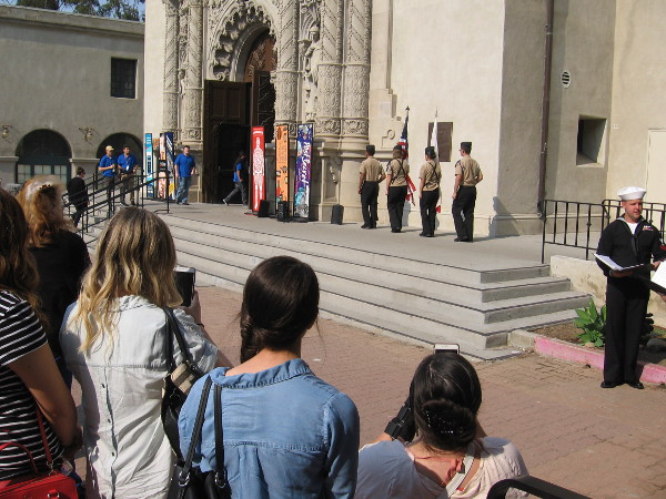 Flags advance to the front of the Museum of Man.