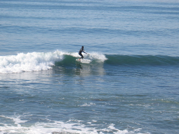 A lone surfer has caught a good wave!