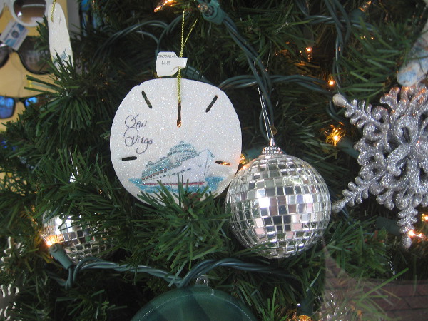 San Diego sand dollar and disco ball ornaments inside the window of Best of Gaslamp.