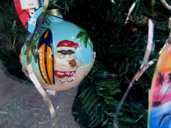 A funny surfing Santa ornament in the window of San Diego Trading Company!