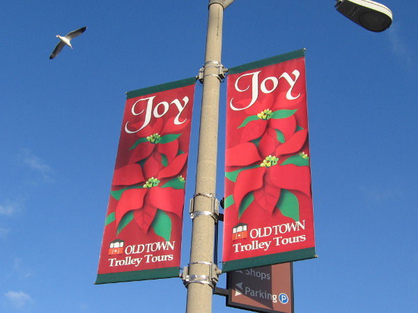 Old Town Trolley Tours wishes everyone Joy with their bright banners.