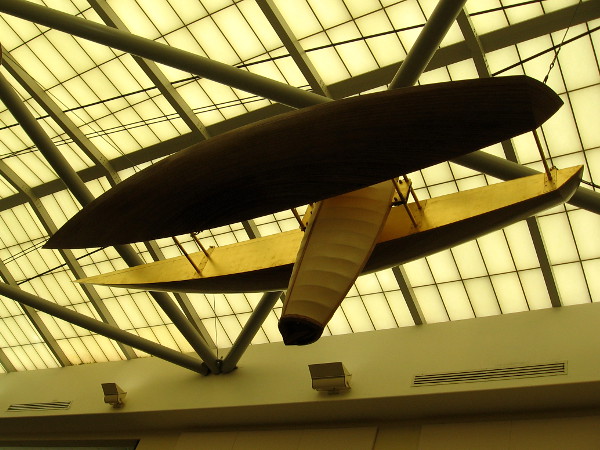A sculpture of an abstract catamaran is suspended beneath a large skylight at the La Jolla Library.